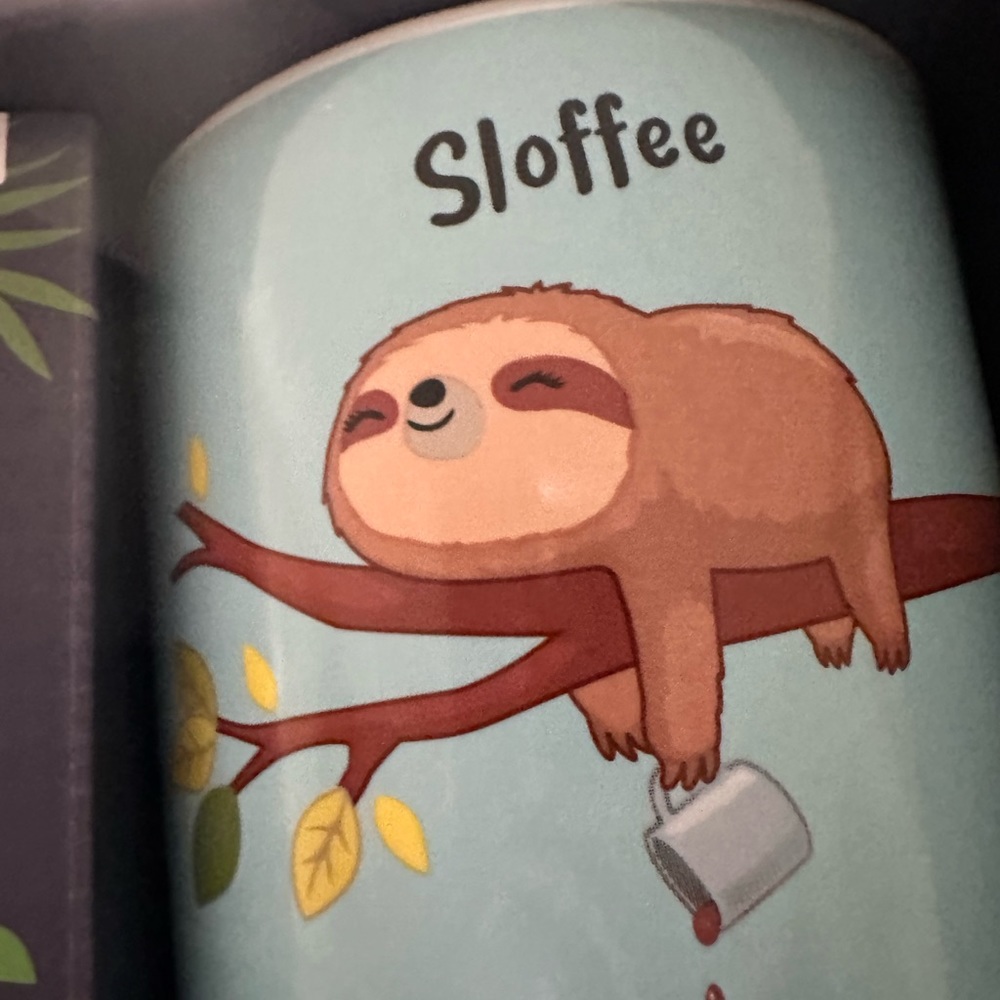 Coffe cup drink it slow!!! Like a sloth!!! He is sooo cute. New in box.